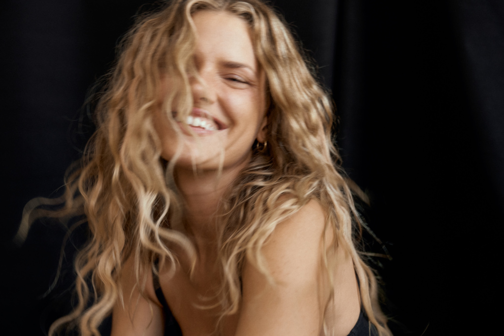 Young blonde woman laughing