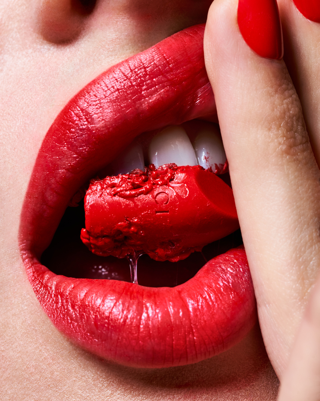 Close up of a mouth with red lipstick in teeth
