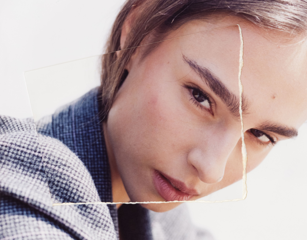 Crop of a woman's face with a photo superimposed on top of her