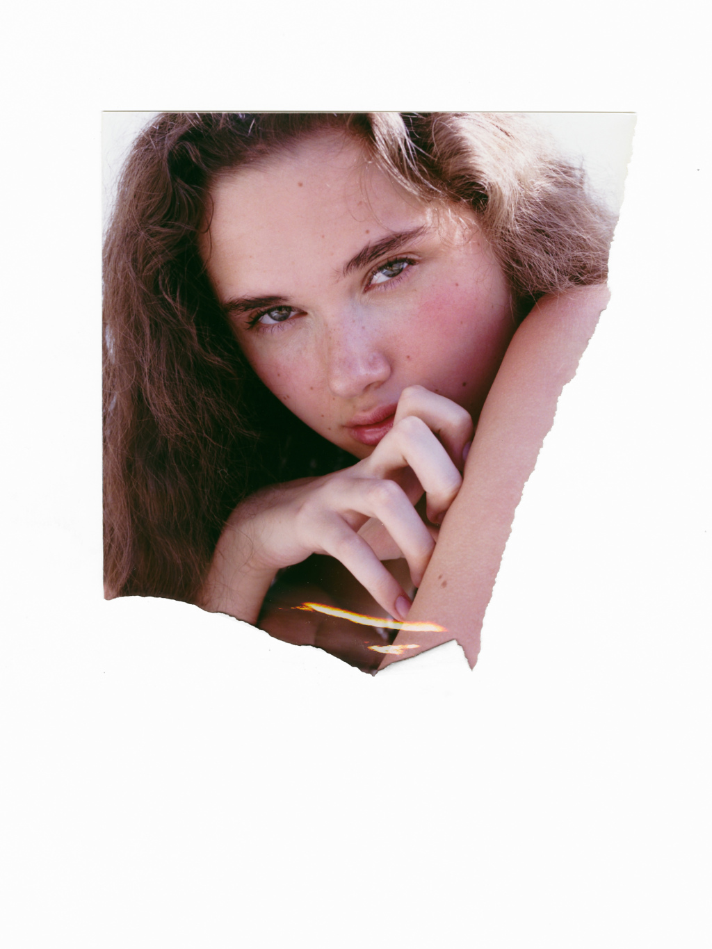 Detail of a young woman's face with long dark curly hair